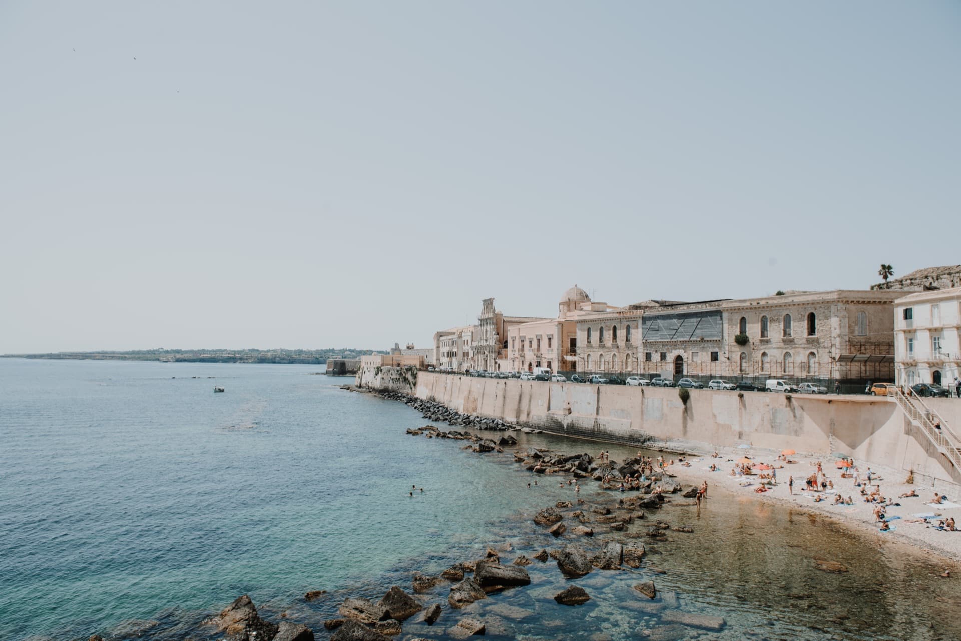 The Ortigia seafront, stone buildings above the water