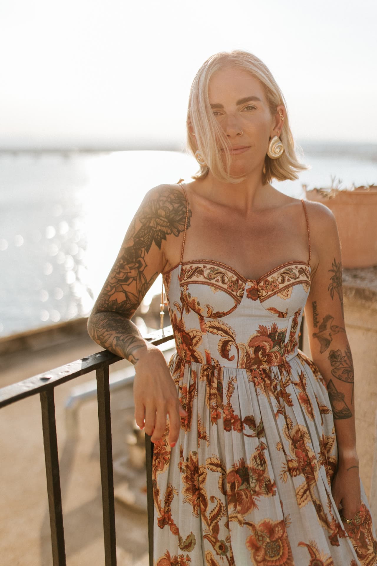 Kat Moore at golden hour on the Lula Mare balcony in Ortigia