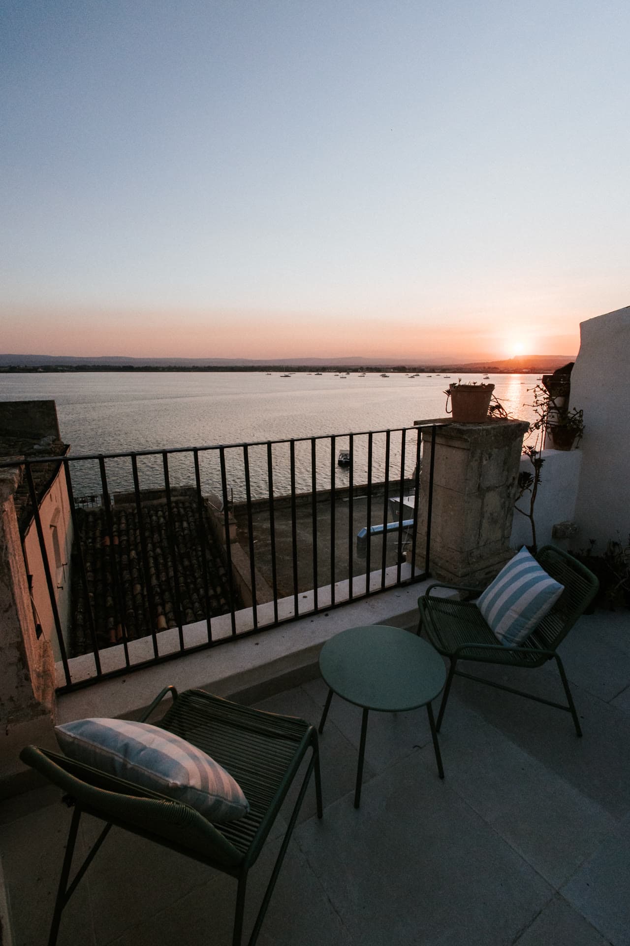 The Lula Mare balcony at sunset over the Ortigia harbor