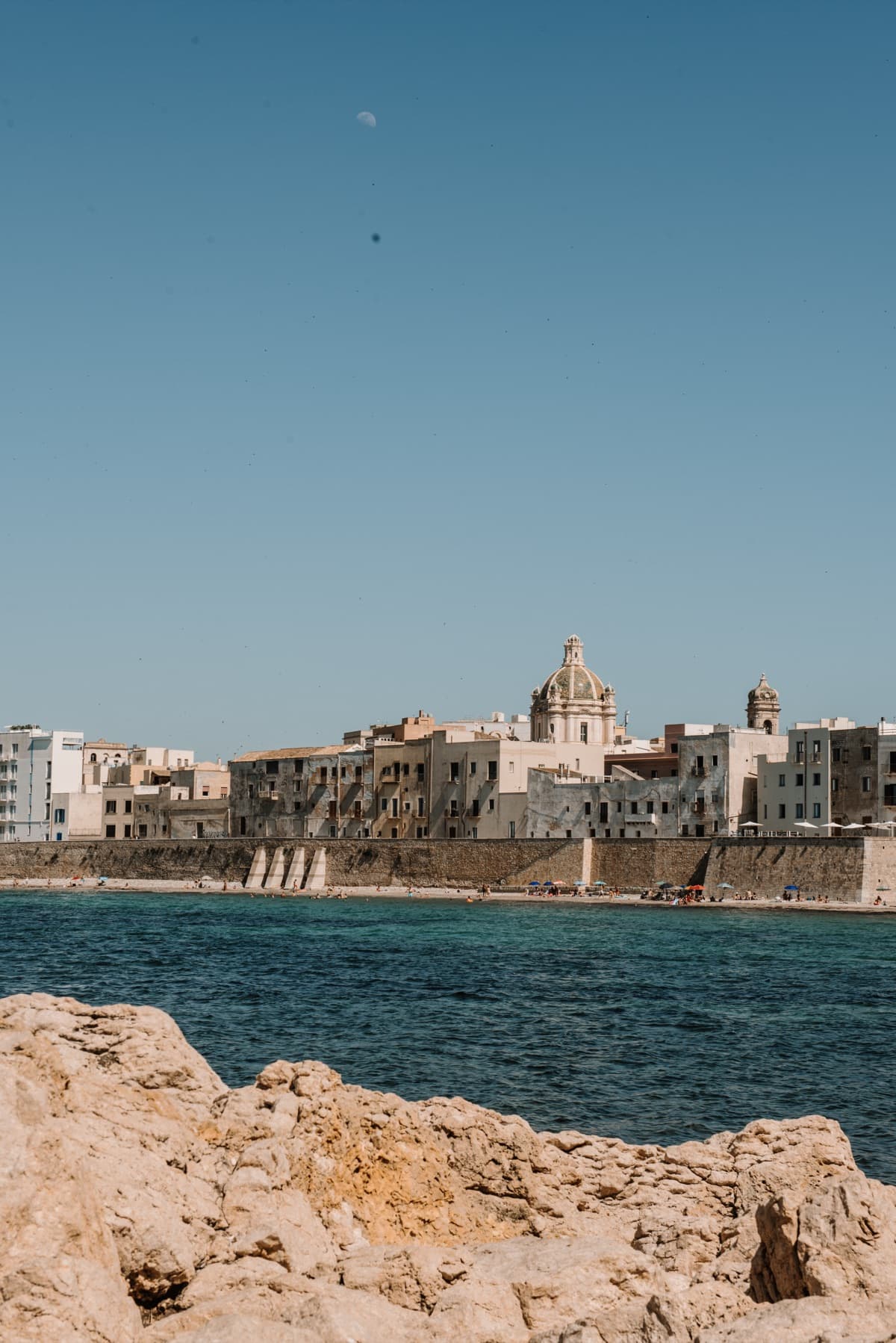 The seafront of Trapani under a deep blue evening sky, edited with the Tramonto preset